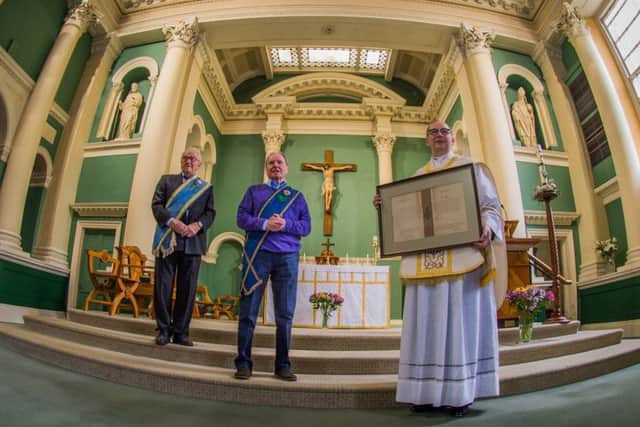 Date: 17th May 2017.
Picture James Hardisty.
A handwritten blessing for a Yorkshire church sent by Pope Pius X in 1908 has been uncovered in an attic after being lost for 60 years and has been presented back to the parish priest at St Austin's Church, Wentworth Terrace, Wakefield. Pictured (left to right) Norman Hazell, President of the Catholic Young Mens Society, and Michael Timlin, Secretary of the Catholic Young Mens Society with Monsignor David Smith, holding the discovered letter.
