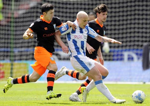 Huddersfield Towns Aaron Mooy, seen in play-off semi-final action against Sheffield Wednesday, will be out to sink Reading on Monday (Picture: Steve Ellis).
