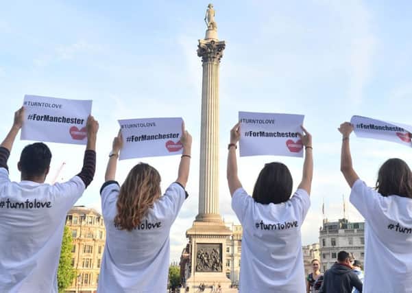People attend a peace vigil in Trafalgar Square following the Manchester suicide bombing.