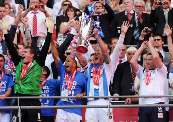 Peter Clarke lifts the trophy after Huddersfield Town's dramatic League One win against Sheffield United five years ago.