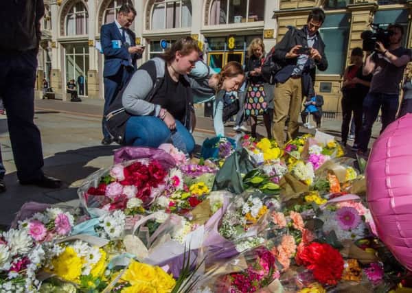 Floral messages and tributes being layed in St Ann's Square, Manchester.