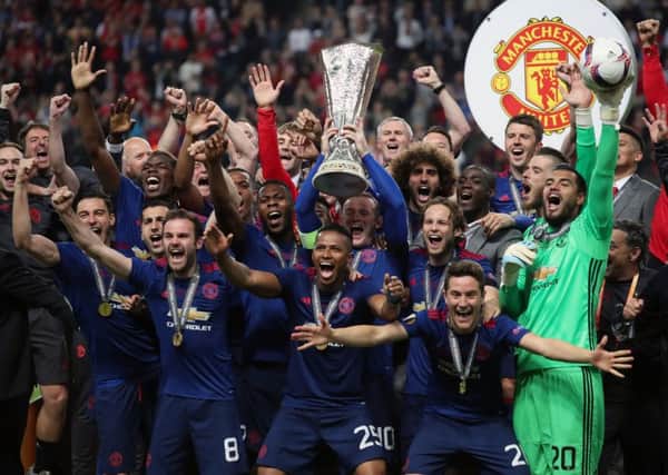 Manchester United's Wayne Rooney lifts the trophy as he and his team-mates celebrate winning the Europa League final (Picture: Nick Potts/PA Wire).