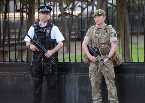 A soldiers joins police outside the Palace of Westminster, London. PIC: PA