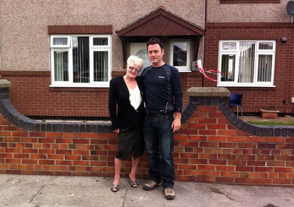 Pools winner Viv Nicholson with her son Howard Nicholson taken outside their old house in Castleford.