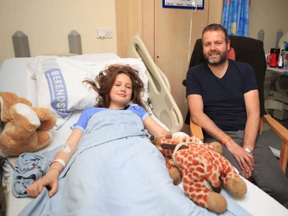 Evie Mills, 14 from Harrogate, with her Dad,Craig, in the Royal Manchester Children's Hospital where she is being treated after the terror attack in the city earlier this week. PA