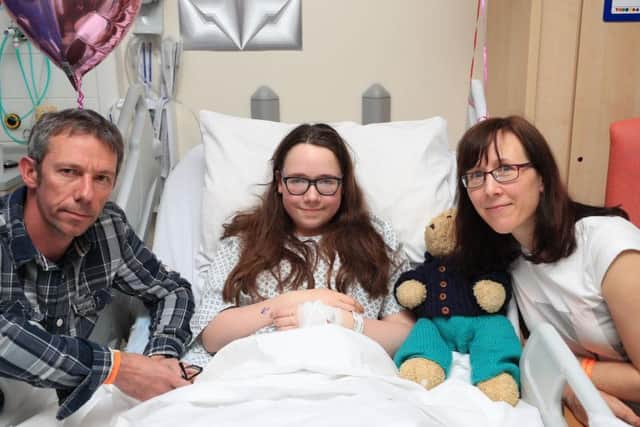 Amy Barlow, 12, from Rawtenstall, Lancashire, with her mother, Kathy, and father, Grant, in the Royal Manchester Children's Hospital where she is being treated after the terror attack in the city earlier this week. PA