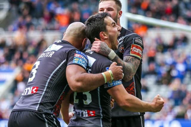 Castleford's Tom Holmes celebrates his try with Jake Webster and Zak Hardaker. Picture by Alex Whitehead/SWpix.com