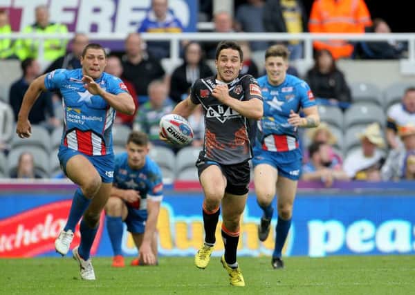 Castleford Tigers' Tom Holmes runs the length of the pitch to score a try against Leeds at St James' Park. Picture: Richard Sellers/PA