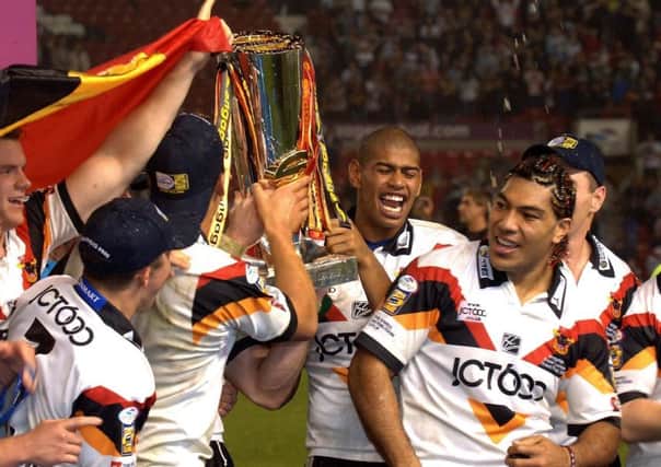 Try scorers Leon Pryce and Lesley Vainikolo join the celebrations as Bradford Bulls lift the Grand Final trophy after defeating Leeds Rhinos at Old Trafford in 2005. P: John Giles/PA