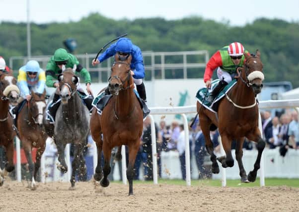 Antiquarium ridden by James McDonald (centre, blue silks) beats Seamour ridden by Ben Curtis (right) to win the John Smith's Northumberland Plate at Newcastle last year. Picture: Anna Gowthorpe/PA