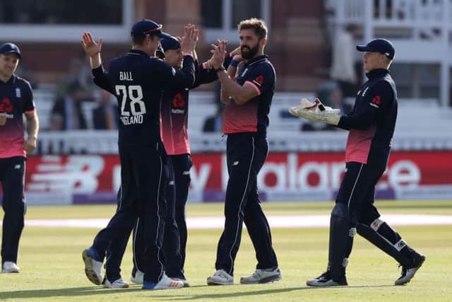 Liam Plunkett is congratulated by his England ODI team-mates after taking a wicket. Picture: John Walton/PA