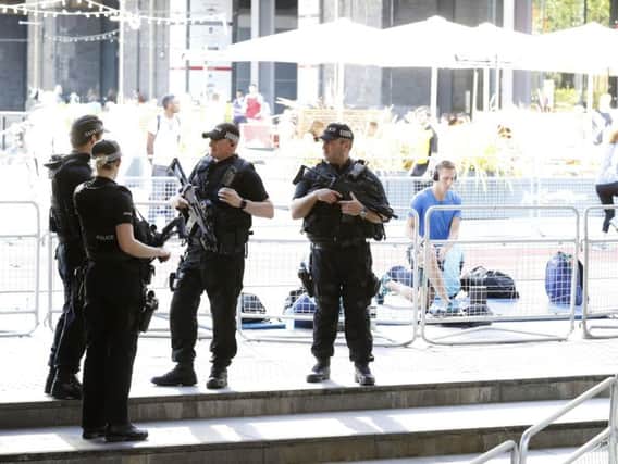 Armed police operating during the Arcadis Great City Games at Deansgate, Manchester on Friday night. More arrests have now been made in connection with the bomb attack which killed 22 people.