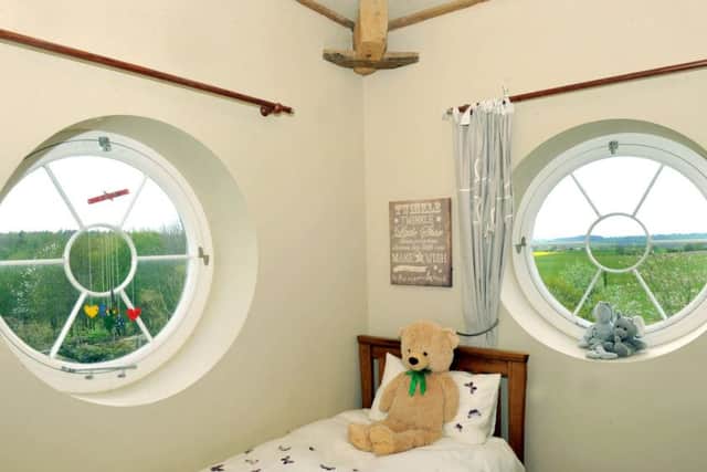 Eleizabeth's room in the tower with round windows bringing light and views