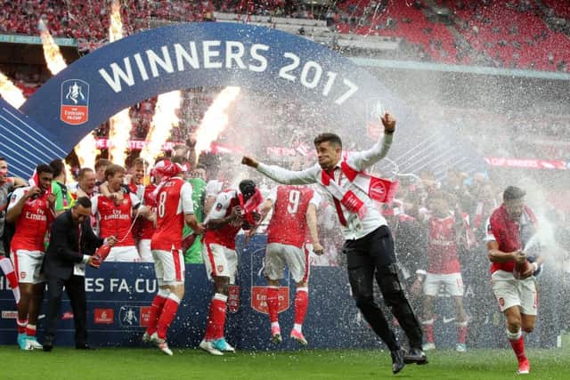 Arsenal's Gabriel celebrates with team-mates after winning the FA Cup against Chelsea at Wembley. Picture: Nick Potts/PA