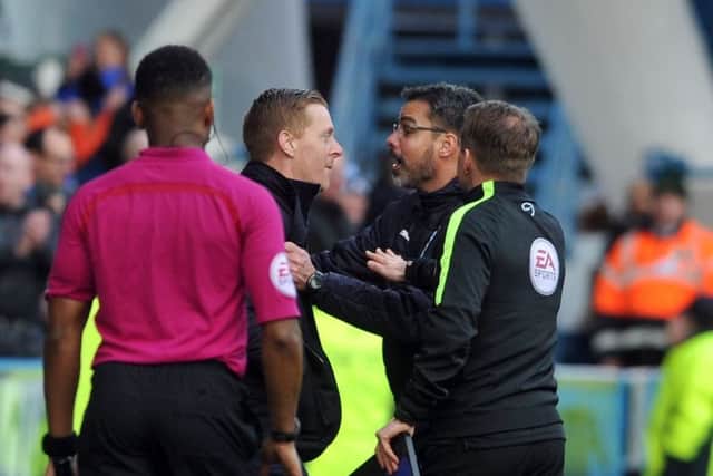 THAT incident: Garry Monk confronts counterpart David Wagner after he celebrated his team's winner on the pitch with the players.