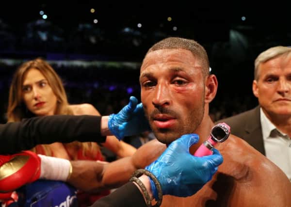 Kell Brook is checked over by the medical team after his IBF Welterweight title loss to Errol Spence at Bramall Lane. Picture: Richard Sellers/PA.