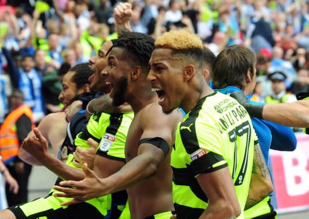 Huddersfield Town players are ecstatic after winning promotion to the Premier League (Picture: Simon Hulme).