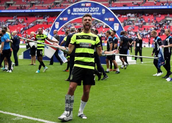 Huddersfield Town's Tommy Smith celebrates on crutches after winning the Championship play-off final at Wembley (Picture: Nick Potts/PA Wire).