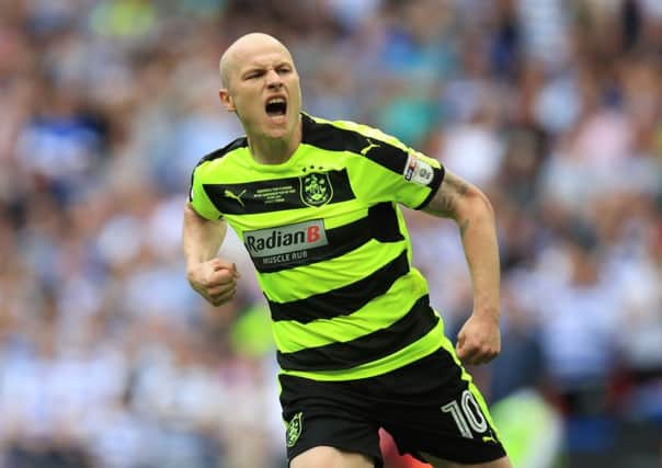 Huddersfield midfielder Aaron Mooy will not address his future until he has celebrated promotion to the Premier League.