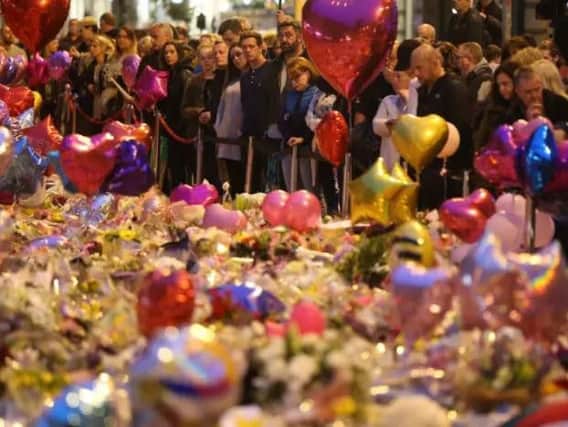Flowers and balloons are laid in honour of those who died in Manchester.