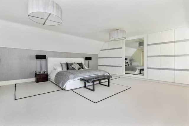 One of the bedrooms with built-in storage by Clarity Arts