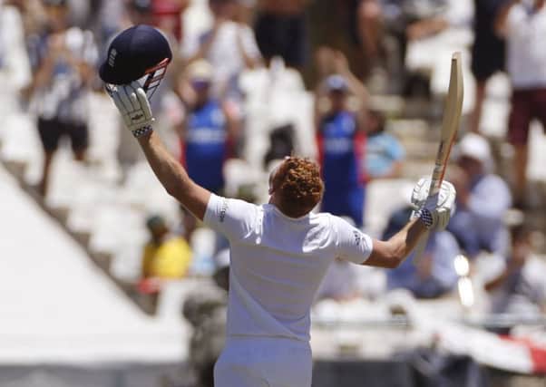 England's Jonny Bairstow making his century with Ben Stokes, left, during their second cricket Test against South Africa in Cape Town, South Africa, Sunday, Jan. 3, 2016. (AP Photo/Schalk van Zuydam)