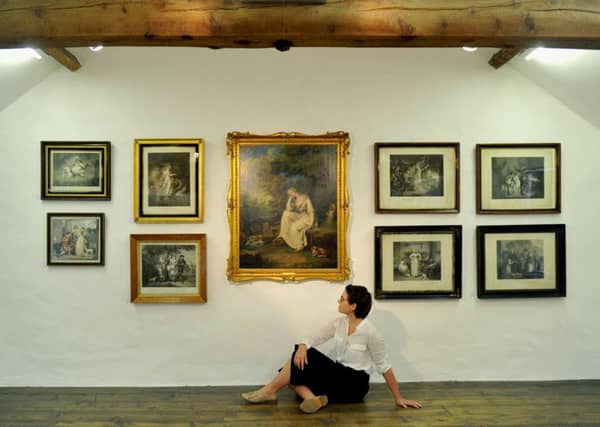 Exhibitions officer Olivia Threlkeld at Shandy Hall with some of the 18th century literary prints