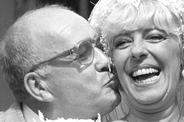 Bet Lynch (actress Julie Goodyear) getting a kiss from television groom Alec Gilroy (Roy Barraclough)
