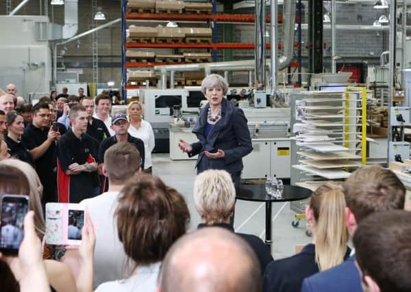 Conservative party leader Theresa May speaking to staff at Ultima Furniture in Moorthorpe, South Kirby
