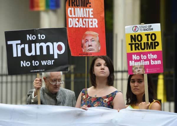 Protestors outside the American Embassy on central London ahead of US President Donald Trump's announcement on whether the United States pulls out of the Paris Agreement on climate change. PRESS ASSOCIATION Photo. Picture date: Thursday June 1, 2017. Trump has said he will announce whether he intends to go ahead with his election campaign pledge to withdraw from the landmark 2015 deal to reduce CO2 emissions.See PA story ENVIRONMENT Climate. Photo credit should read: David Mizoeff/PA Wire