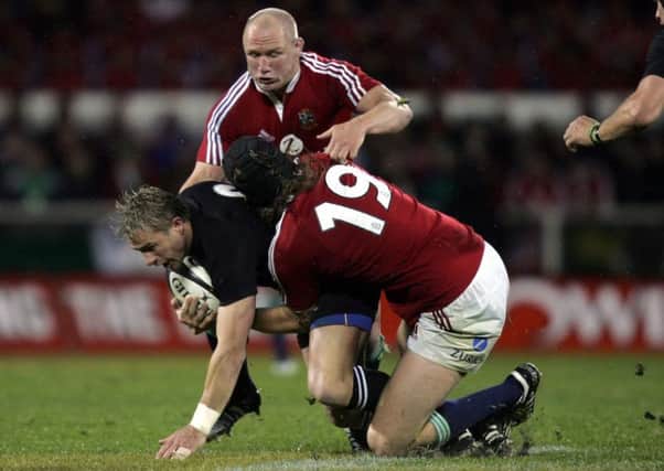 New Zealand's Justin Marshall is caught by British and Irish Lions duo Neil Back and Ryan Jones during the First Test at the Jade Stadium, Christchurch in  June 2005 (Picture: David Davies/PA).