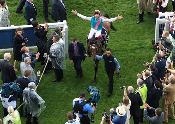 Jockey Frankie Dettori celebrates after his winning ride on Enable in the Investec Oaks.