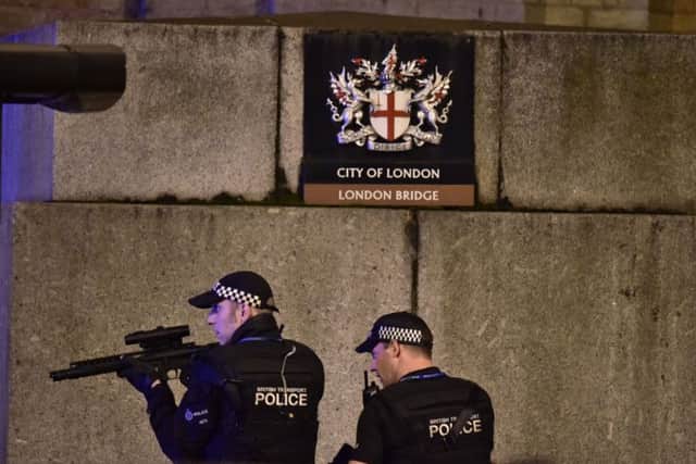 Armed Police officer looks through his weapon on London Bridge as  police are dealing with a "major incident" at London Bridge.