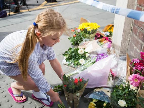 Ryleigh Goldswain, 5, lays flowers near London Bridge, where a terror attack took place on Saturday.