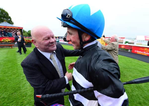 Jockey Chris Hayes with trainer David Nicholls after the Dubai Duty Free Full Of Surprises Celebration Stakes at the Curragh Racecourse, Ireland, in 2015.