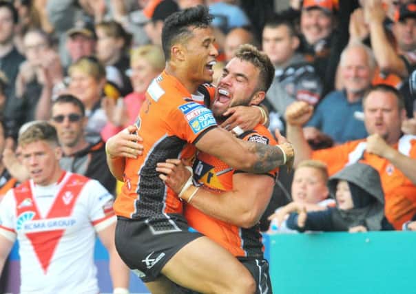 Mike McMeeken celebrates with Ben Roberts as Castleford overcame having to play a third game in nine days to defeat refreshed St Helens (Picture: Steve Riding).