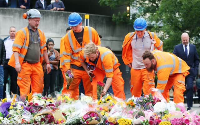 People lay flowers near London Bridge following Saturday's terrorist attack.
