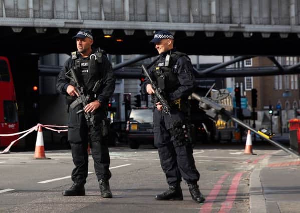 Armed police guard an area close to Borough Market in London following Saturday's attack. Picture: Isabel Infantes/PA Wire