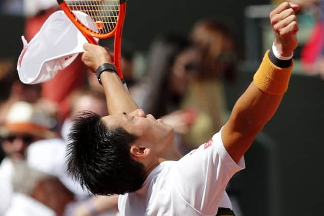 Japan's Kei Nishikori raises his arms as he defeats Spain's Fernando Verdasco during their fourth round match of the French Open tennis tournament at the Roland Garros stadium, Monday, June 5, 2017 in Paris. (AP Photo/Christophe Ena)