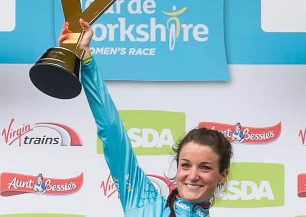 Lizzie Deignan lifts the trophy aloft after winning the women's race at the Tour de Yorkshire