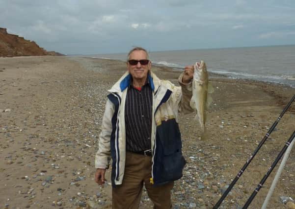 Stewart Calligan with a cod caught fishing on Tunstall beach, known for its carboniferous corals.