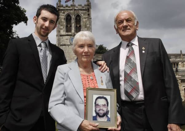 Pictured before the 2012 memorial service to mark the 20th anniversary of the murder of Special Constable Glenn Goodman are his son Thomas and parents Margaret and Brian. (120614M2a)