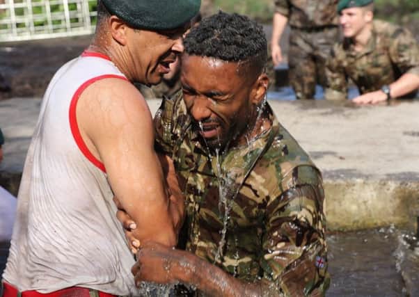 England's Jermain Defoe exits the 'sheep dip'' on the Royal Marines Endurance Course. The England squad experienced a different kind of boot camp over the weekend after manager Gareth Southgate arranged a top secret trip to the Royal Marines' Commando Training Centre. (Picture: Royal Navy/PA Wire)