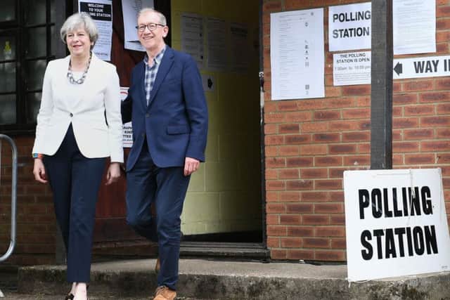 Theresa May and her husband Philip after casting their votes.