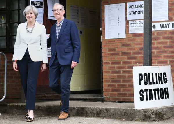 Theresa May and her husband Philip after casting their votes.