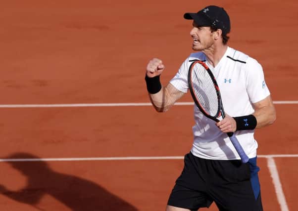 Britain's Andy Murray clenches his fist as he defeats Japan's Kei Nishikori during their quarterfinal match of the French Open tennis tournament. (AP Photo/Christophe Ena)