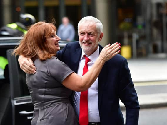 Labour leader Jeremy Corbyn receives a hug from his Office Director Karie Murphy as he arrives at Labour Party HQ in Westminster after he called on the Prime Minister to resign, saying she should "go and make way for a government that is truly representative of this country". Picture: Dominic Lipinski/PA Wire