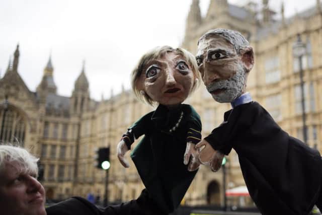Two anti-Brexit activists pose with their hand-puppets