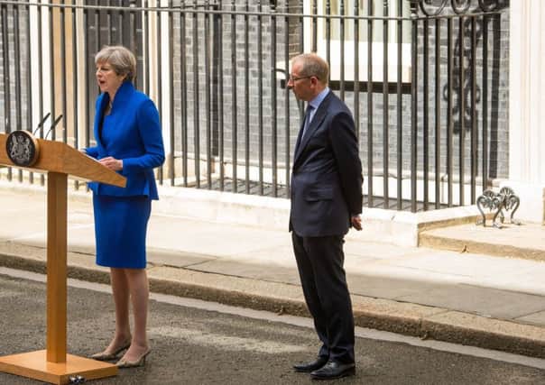 Prime Minister Theresa May, accompanied by her husband Philip, makes a  statement in Downing Street after receiving permission from the Queen to form a new government.