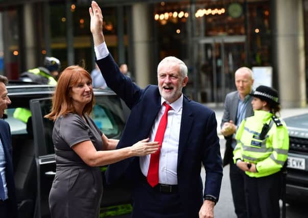 A triumphant Jeremy Corbyn arrives at Labour's HQ after the election.